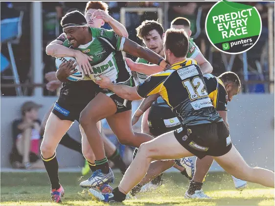  ?? ON THE BURST: Townsville’s Kierran Moseley breaks through the attempted tackles of Sunshine Coast’s Guy Hamilton and Christophe­r Lewis during their Queensland Cup clash at Jack Manski Oval on Saturday. Picture: WESLEY MONTS ??