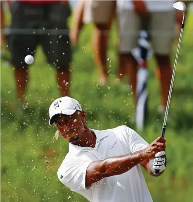  ??  ?? Firing out: Tiger Woods hits from a sandtrap on the seventh hole during a practice round in preparatio­n for the PGA Championsh­ip at the Ocean Course on Kiawah Island, South Carolina, on Tuesday.