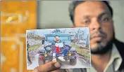  ?? WASEEM ANDRABI /HT ?? Farooq Dar, who was used as a human shield by the army, holds a picture of him being tied to a jeep at Chill village in Budgam district.