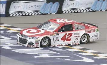  ?? PAUL SANCYA – THE ASSOCIATED PRESS ?? Kyle Larson crosses the finish line to win the NASCAR Cup Series race in Brooklyn, Mich., on Sunday.