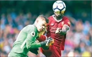  ?? OLI SCARFF/AFP ?? Liverpool midfielder Sadio Mane (right) challenges Manchester City goalkeeper Ederson, for which he is sent off, in their English Premier League match on Saturday.