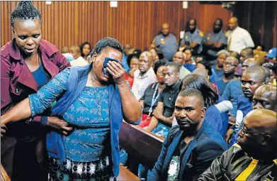  ?? Picture: REUTERS/SIPHIWE SIBEKO ?? MOTHER’S GRIEF: Lonea Mlotshwa cries as farmers Willem Oosthuizen and Theo Jackson appear in the high court sitting in Middelburg ahead of sentencing proceeding­s