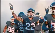  ?? STEPHEN DUNN/AP PHOTO ?? In this Aug. 30 file photo, UConn linebacker Eli Thomas (22) raises his arms to the crowd as the team enters the field for their season-opening game against Central Florida at East Hartford.