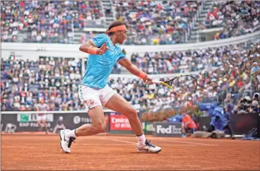  ??  ?? Rafael Nadal of Spain returns the ball to Stefanos Tsitsipas of Greece during a semifinal match at the Italian Open tennis tournament, in Rome, on Saturday.