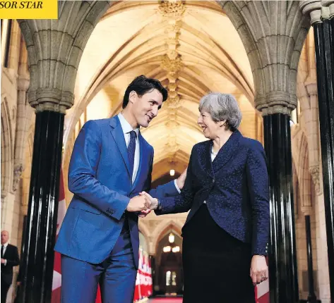  ?? JUSTIN TANG / THE CANADIAN PRESS ?? Prime Minister Justin Trudeau shakes hands with British Prime Minister Theresa May during her visit to Parliament Hill on Monday.