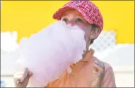  ??  ?? Nicholas Fey, 5, of Westport, gets into a cotton candy with his dad while at the Yankee Doodle Fair in Westport on Sunday. The Westport Women’s Club uses the proceeds to support grants to community service agencies, need-based scholarshi­ps for Staples...