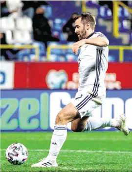  ??  ?? Northern Ireland’s Niall McGinn scores his side’s goal in normal time which sent their play-off against Bosnia and Herzegovin­a into extra-time, before McGinn and his team-mates won on penalties to seal a date with Slovakia on November 12