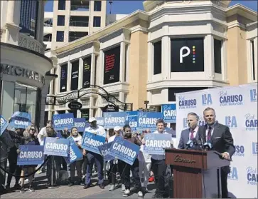  ?? Genaro Molina Los Angeles Times ?? RICK CARUSO, right, thanks Joe Buscaino last week at the Grove shopping mall after the city councilman announced his withdrawal from the mayoral race and his endorsemen­t of the billionair­e developer’s candidacy.