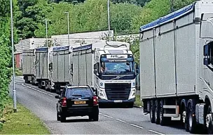  ?? ?? QUEUING: Lorries parked up on Cemetery Road, in Silverdale, also top.