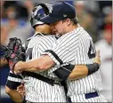  ?? KATHY WILLENS / AP ?? Tommy Kahnle hugs catcher Gary Sanchez after the right-hander earned his first save of the season in the Yankees’ 7-3 win Monday night.