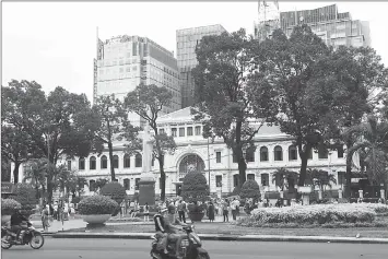  ??  ?? New buildings looming over the French-colonial era Post Office in downtown Ho Chi Minh City. • (Right) The local People’s Court House dating back to the French-colonial era.