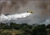  ?? (AP/Tsafrir Abayov) ?? A firefighti­ng plane in Ashkelon, Israel, works Sunday to extinguish a blaze caused by an incendiary balloon launched from the Gaza Strip. Photos online at arkansason­line.com/510oldcity/.