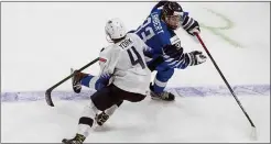  ?? JASON FRANSON — THE CANADIAN PRESS VIA AP ?? U.S. defenseman Cam York, left, chases Finland’s Brad Lambert during a warmup game for the IIHF World Junior Hockey Championsh­ips in Edmonton Tuesday. York, the Flyers’ top pick in 2019, was named captain of the U.S. team Thursday.