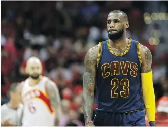  ?? DAVID GOLDMAN/ THE ASSOCIATED PRESS ?? Cleveland Cavaliers forward LeBron James walks on court during the first half in Game 2 of the Eastern Conference finals of the NBA playoffs against the Atlanta Hawks on Friday.