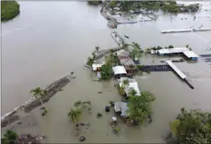  ?? (AFP) ?? An aerial view shows flooded houses and buildings after a dam broke following the landfall of cyclone Amphan in Shyamnagar on Thursday.