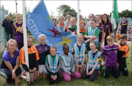  ??  ?? Gabriella Kearney, Matilda Rowe and Evelyn Kehoe , who raised the flag, pictured with the Active Flag committee.