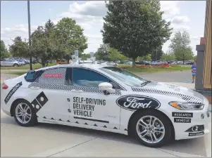  ?? AP PHOTO/DEE-ANN DURBIN ?? This Aug. 24 photo shows the specially designed delivery car that Ford Motor Co. and Domino’s Pizza will use to test self-driving pizza deliveries, at Domino’s headquarte­rs in Ann Arbor, Mich.