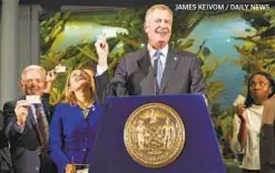  ?? JAMES KEIVOM / DAILY NEWS ?? Mayor de Blasio touts city ID card, but some immigrant groups do not support it, fearing a chip inside it could collect personal data.