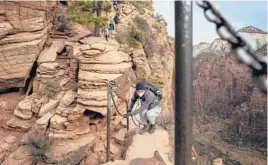  ??  ?? Hikers used the chains along a portion of the Angels Landing trail in Zion National Park in Utah.