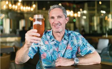  ?? MATIAS J. OCNER mocner@miamiheral­d.com ?? Manny Portuondo, CEO of Cerveceria La Tropical, with a glass of La Tropical’s La Original at his brewery and taproom in Wynwood.