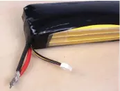  ??  ?? Left: Place the battery in a fireproof container (not shown) and attach the bulb to discharge the pack. Right: After the pack is fully discharged, snip off the connector for reuse, then strip and twist the battery leads together. The pack is ready for recycling or disposal.