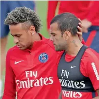  ?? — Reuters ?? PSG’s Brazilian superstar Neymar and compatriot Dani Alves during a training session on Friday.