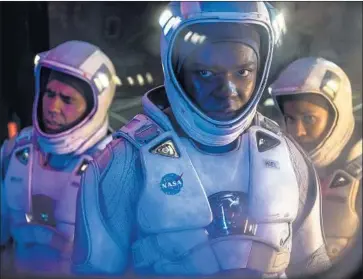 ?? Photograph­s by Scott Garfield Netf lix ?? DAVID OYELOWO, center, with John Ortiz, left and Gugu Mbatha-Raw as crew members of a space station.