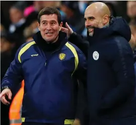  ??  ?? Manchester City manager Pep Guardiola shares a joke with Nigel Clough