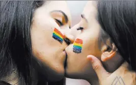  ?? Nelson Antoine ?? The Associated Press Revelers kiss during the annual gay pride parade Sunday in Sao Paulo. The parade focused on Brazil’s national elections scheduled for October.