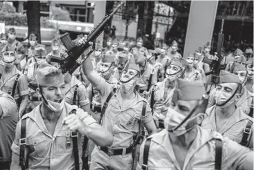  ?? MANU FERNANDEZ/AP ?? Spain’s day: Members of La Legion, an elite unit of the Spanish army, celebrate Tuesday before the start of a military parade on national day, also known as “Dia de la Hispanidad” or Hispanic Day, in Madrid. Spain marks Christophe­r Columbus’ arrival in the New World and also salutes Spain’s armed forces. A 1987 law made Oct. 12 the national holiday.