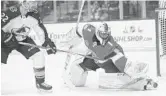  ??  ?? Panthers goaltender Roberto Luongo deflects a shot as Avalanche center Colin Wilson closes in Thursday.