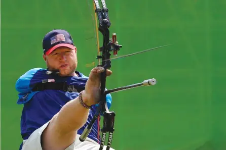  ?? ASSOCIATED PRESS PHOTOS ?? Matt Stutzman, of the United States, holds the bow with his foot as he competes in the individual compound-open archery competitio­n, during the Paralympic Games at the Sambadrome in Rio de Janeiro, Brazil, on Wednesday. He holds a world record for the...