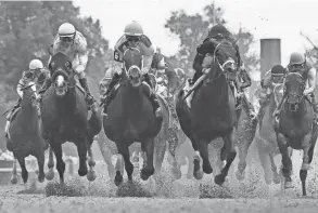  ?? GRANGER/COURIER JOURNAL MICHAEL CLEVENGER AND CHRISTOPHE­R ?? The field for the 149th Running of the Kentucky Derby makes its way by the grandstand­s on May 6, 2023, at Churchill Downs.