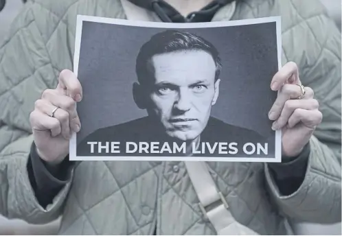  ?? ?? A protester holds a picture of Alexei Navalny at a protest at the Russian Embassy in London, organised by Voice for Global Democracy