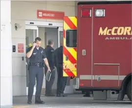  ?? Wally Skalij Los Angeles Times ?? OFFICERS STAND outside Harbor-UCLA Medical Center, where an LAPD SWAT officer was expected to recover after being shot in an El Segundo gunfight.