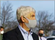  ?? CODY SCANLAN — THE FLINT JOURNAL VIA AP ?? Former Gov. Rick Snyder stays silent as barrage of media asks questions after his video arraignmen­t on charges related to the Flint water crisis, Thursday outside the Genesee County Jail in downtown Flint.