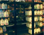  ?? Mona Weatherly ?? Gaps in the selection of some grocery products can be seen at local grocery stores. Above left: Open spaces show there is a limited selection of frozen potato products at The Grocery Kart in Broken Bow. Above right: Nested between full shelves, a column of shelves show no two percent dairy products were delivered to Gary’s Super Foods Monday morning.