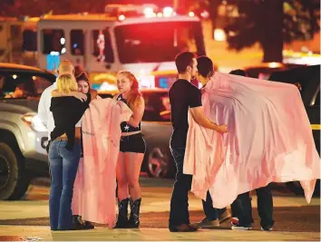  ?? AP ?? People comfort each other near the scene of the attack, in Thousand Oaks, California yesterday.