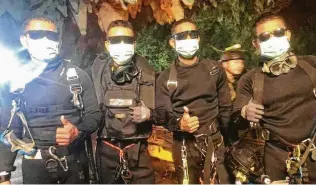  ?? Thai Navy Seals via Associated Press ?? The last four Thai Navy SEALs emerge safely Tuesday after completing the rescue mission inside a cave where 12 boys and their soccer coach have been trapped since June 23.