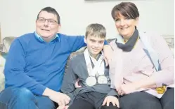  ??  ?? Double medallist Caolan McConville with his parents Peadar and Edel