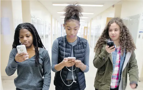  ?? PETER J. THOMPSON / NATIONAL POST ?? Central Toronto Academy Grade 10 students, from left, Kiura F., Andrea A. and Isobel C. at their school on March 3.