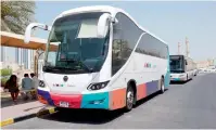  ??  ?? An official checks the new WiFi-enabled luxury bus (below) launched on Sunday to take passengers from Ajman to Rashidiya Metro Station in Dubai. —