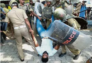  ??  ?? Dramaticar­rest: Police detaining an activist amid protests after women entered the Sabarimala temple, in Kochi in southern Kerala.— AFP