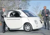  ?? GETTY IMAGES ?? US Transporta­tion Secretary Anthony Foxx (R) and Google Chairman Eric Schmidt (L) get out of a Google selfdrivin­g car at the Google headquarte­rs in California in February 2015