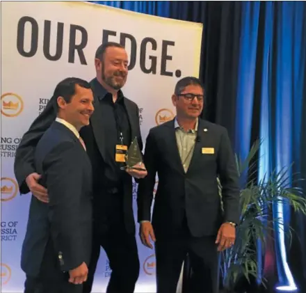  ?? PHOTO BY GARY PULEO ?? Founding Farmers managing partner Darragh Moore, center, accepts the restaurant’s Retailer of the Year award from Eric Davies, left, KOPBID board of directors chair and Eric Goldstein, KOP-BID executive director.