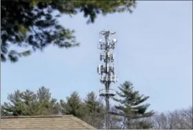  ?? ELISE AMENDOLA — THE ASSOCIATED PRESS ?? In this photo, a cell tower is seen through trees in North Andover, Mass. Insurance companies are using cellphone tower data to deny claims for stolen cars, burned homes and other mishaps, despite the informatio­n coming under question at criminal...