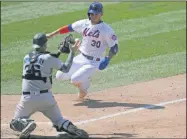  ?? KATHY WILLENS - THE ASSOCIATED PRESS ?? Miami Marlins catcher Ryan Lavarnway, left, prepares to tag out New York Mets’ Michael Conforto (30) at the plate during the fifth inning of a baseball game at Citi Field, Sunday, Aug. 9, 2020, in New York.