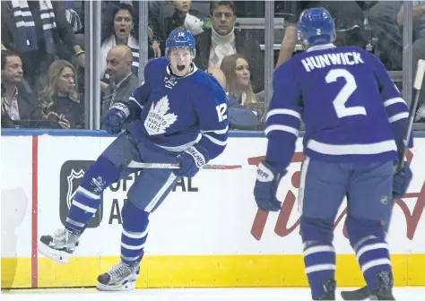  ?? CHRIS YOUNG/THE CANADIAN PRESS ?? Toronto Maple Leafs’ Connor Brown celebrates with teammate Matt Hunwick after scoring his team’s first goal during first period NHL hockey action against the Boston Bruins, in Toronto earlier in the season.