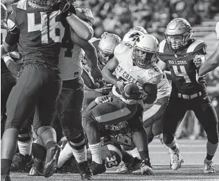  ?? Jerry Baker / Contributo­r ?? Cy Creek running back Eddie Jimerson pushes to the goal line between Summer Creek’s Coral Dahl (4) and Anthony Hall (46).