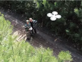  ??  ?? Patrol officers use a drone to access difficult areas of the forest that are nearly impossible to patrol effectivel­y on foot.